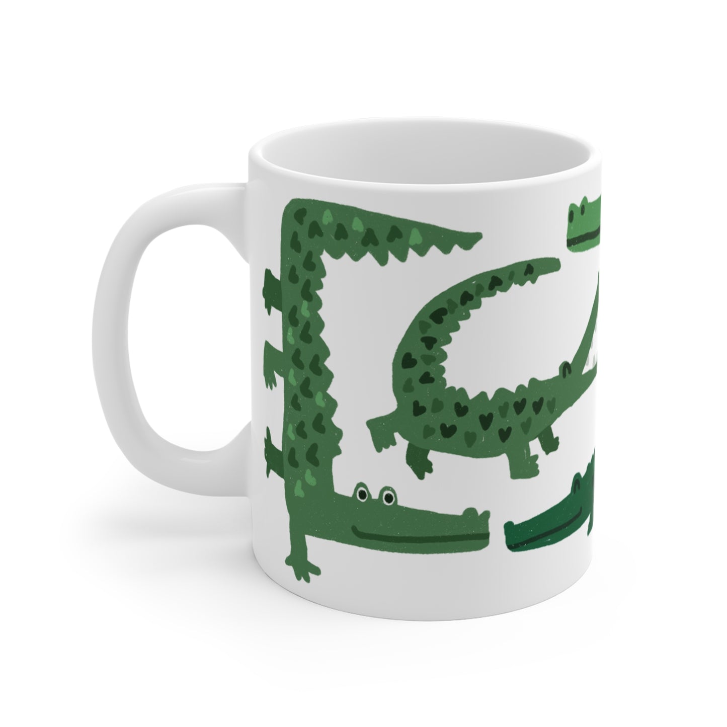 White ceramic mug featuring illustrated green alligators with heart-shaped patterns