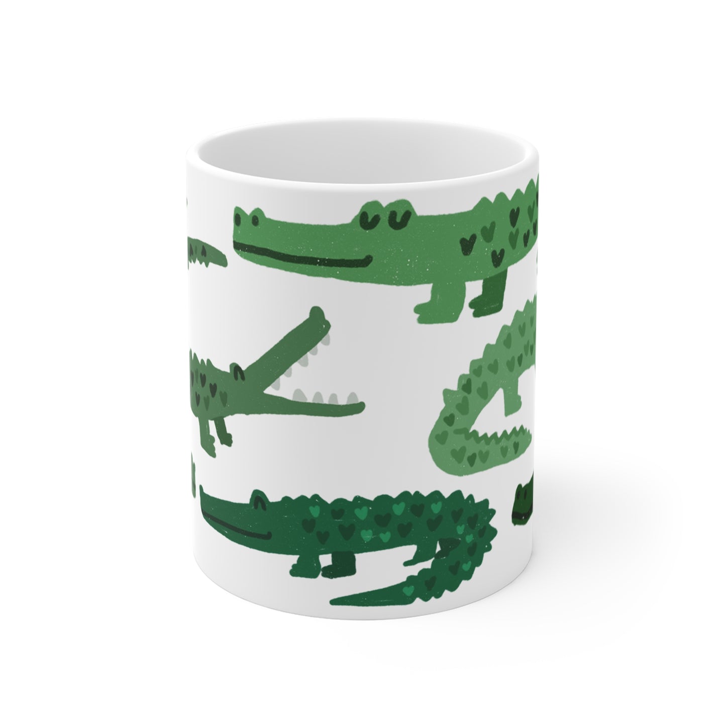 White ceramic mug featuring illustrated green alligators with heart-shaped patterns