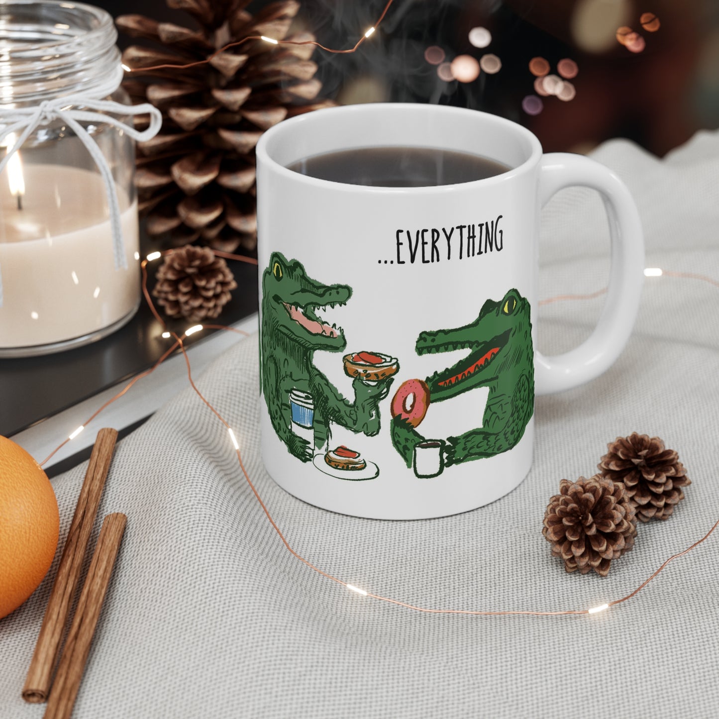Whimsical alligator illustration on ceramic mug featuring two alligators enjoying breakfast with coffee and donuts.