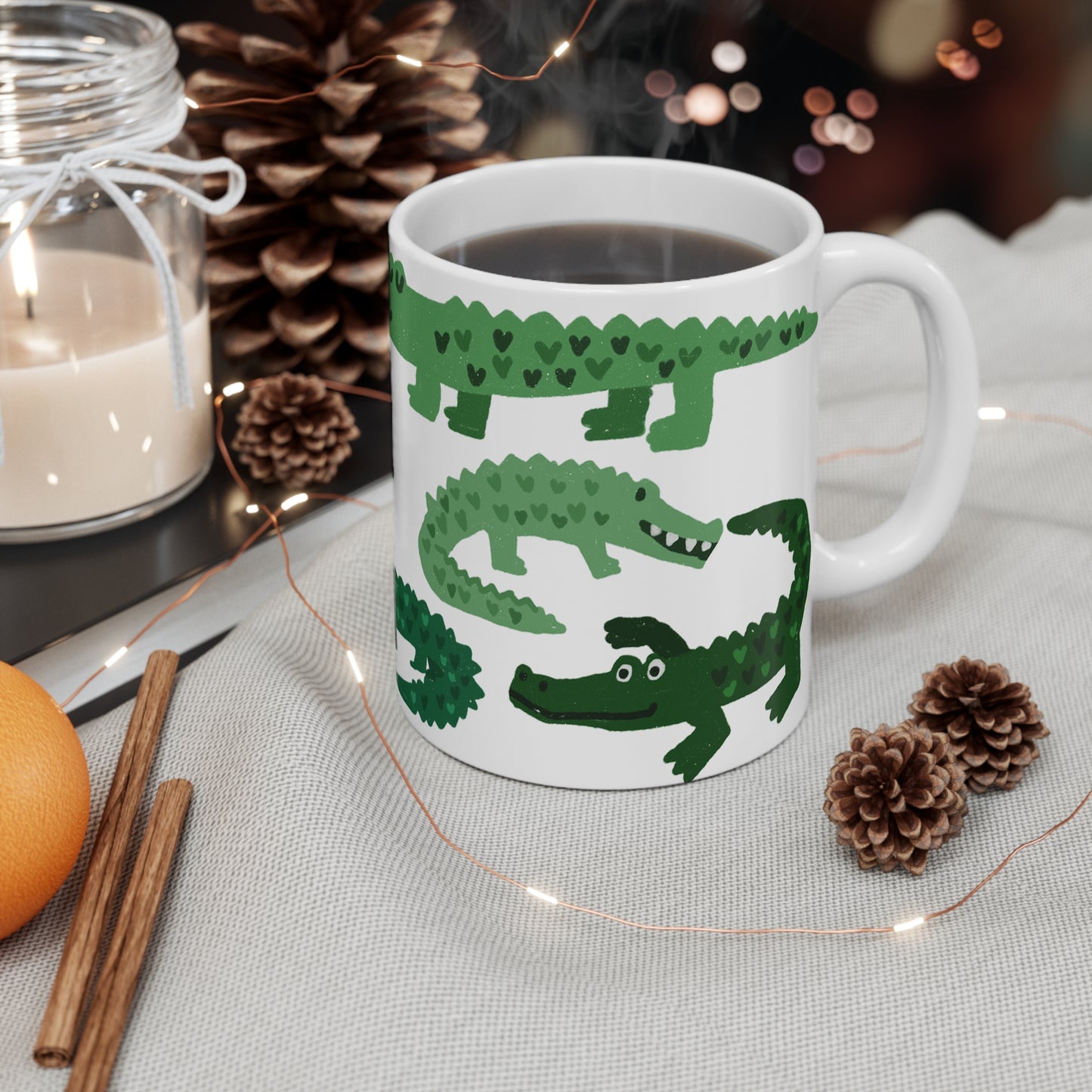 White ceramic mug featuring illustrated green alligators with heart-shaped patterns