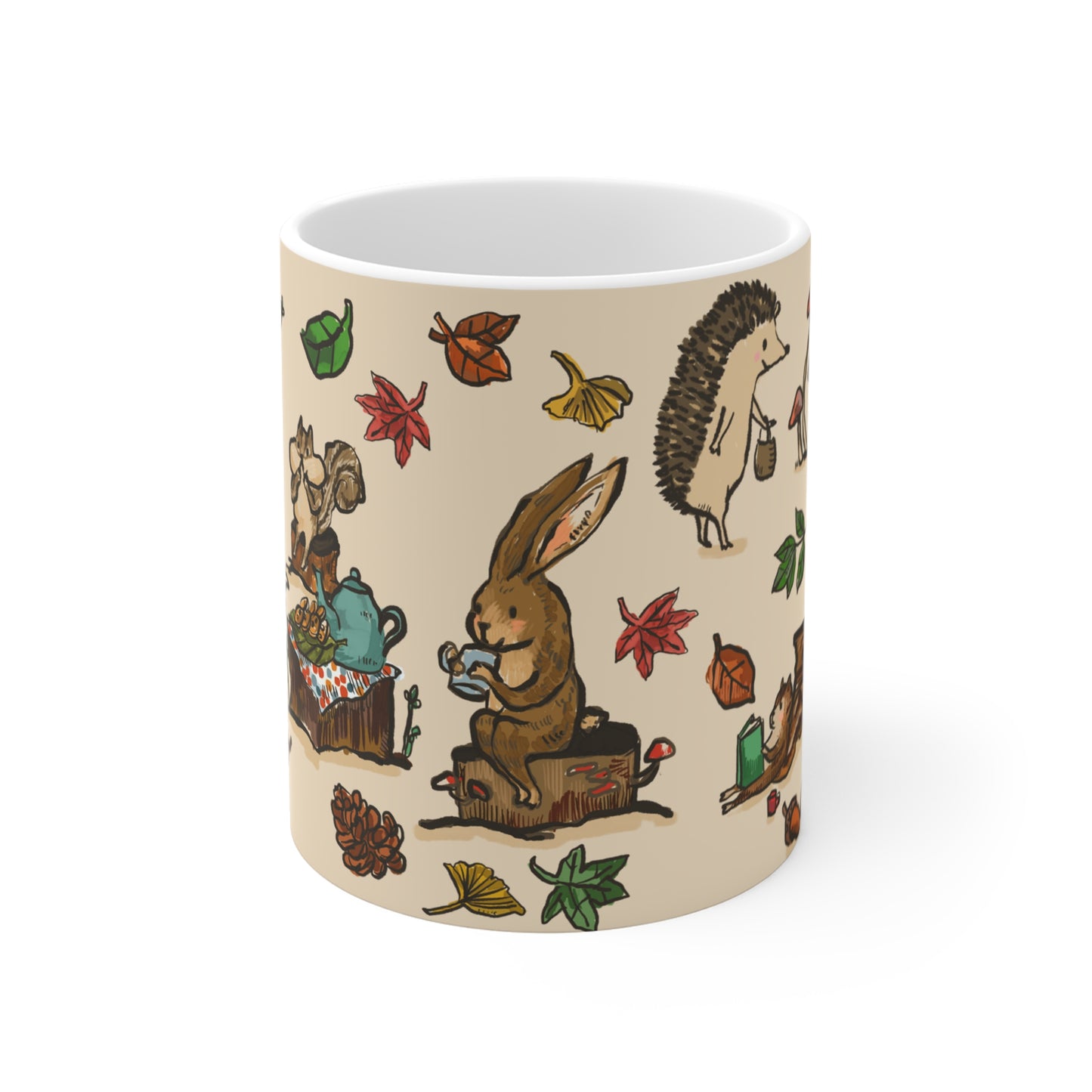 Ceramic mug featuring a whimsical woodland tea party with a fox, rabbit, squirrels, and hedgehogs surrounded by mushrooms, leaves, and books.