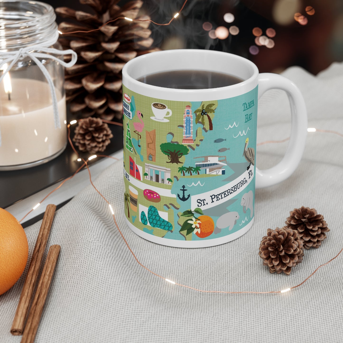 Colorful ceramic mug featuring illustrated St. Petersburg Florida landmarks and coastal design.