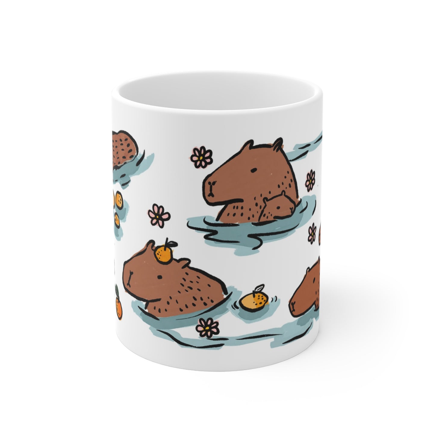 White ceramic mug featuring illustrated capybaras relaxing in a warm bath surrounded by floating oranges and flowers.