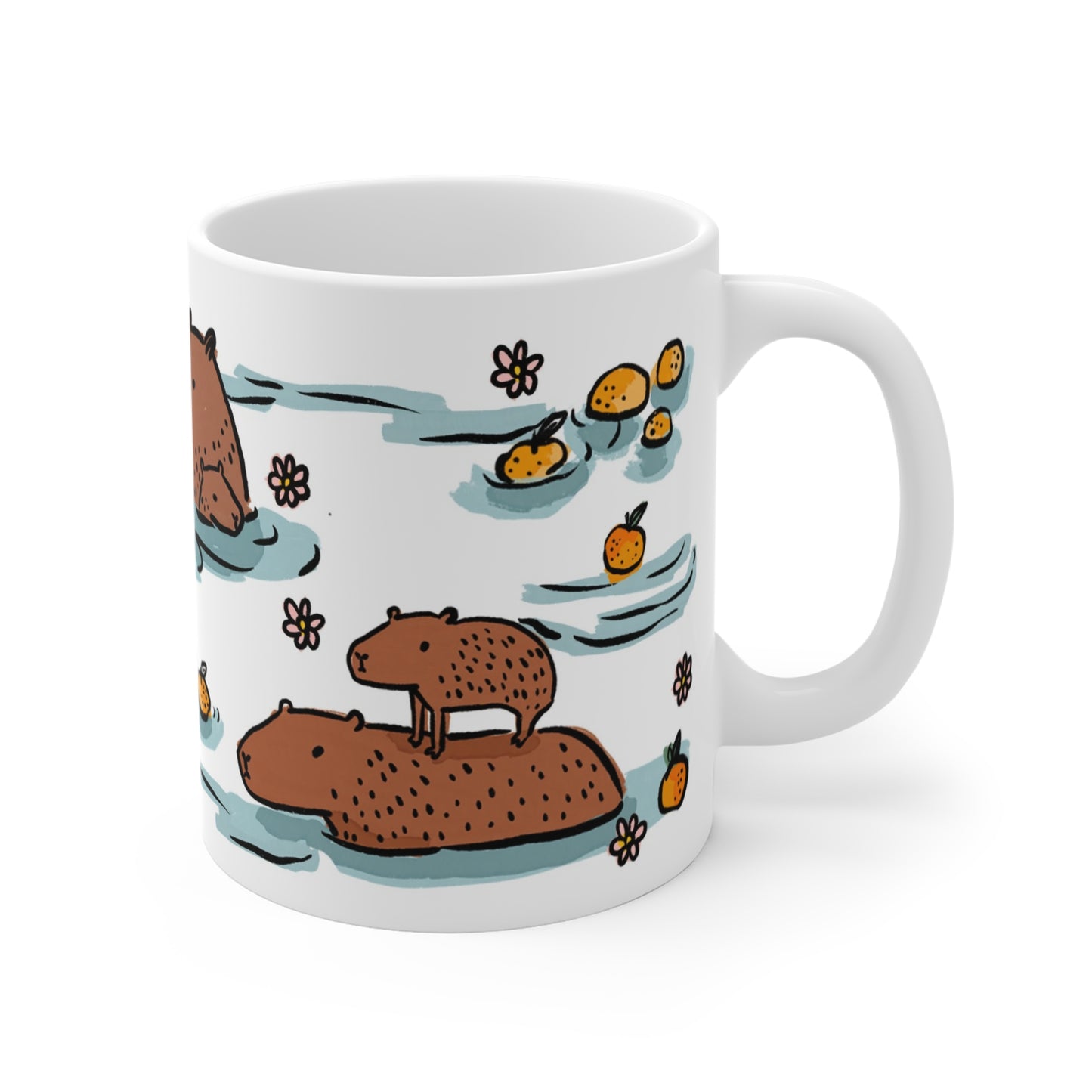 White ceramic mug featuring illustrated capybaras relaxing in a warm bath surrounded by floating oranges and flowers.