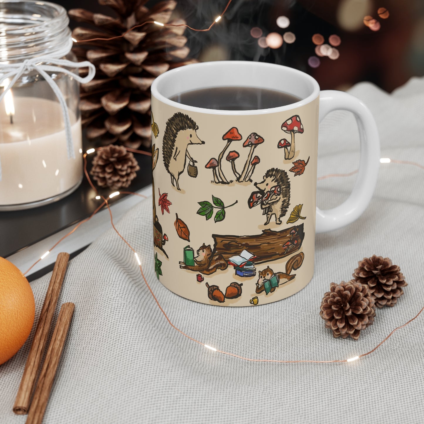 Ceramic mug featuring a whimsical woodland tea party with a fox, rabbit, squirrels, and hedgehogs surrounded by mushrooms, leaves, and books.