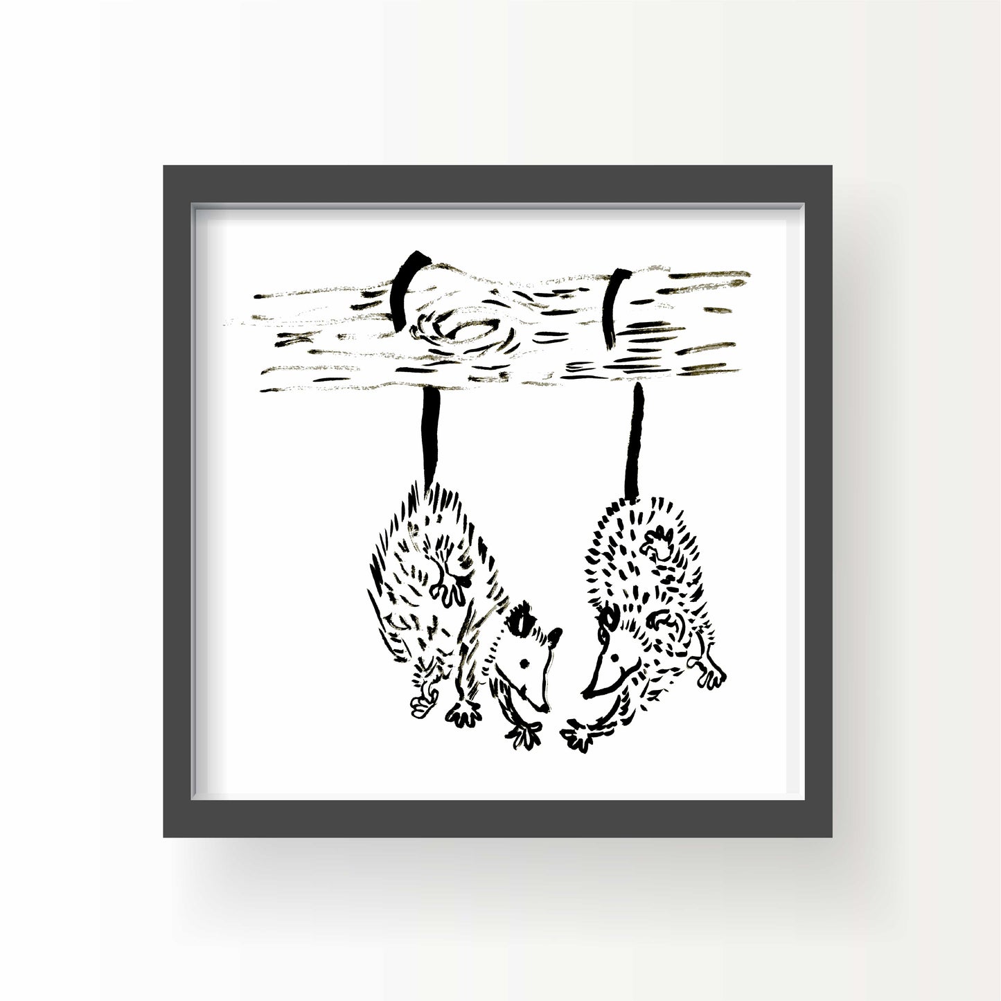Black and white illustration of two opossums hanging upside down by their tails from a tree branch, gently reaching toward one another.