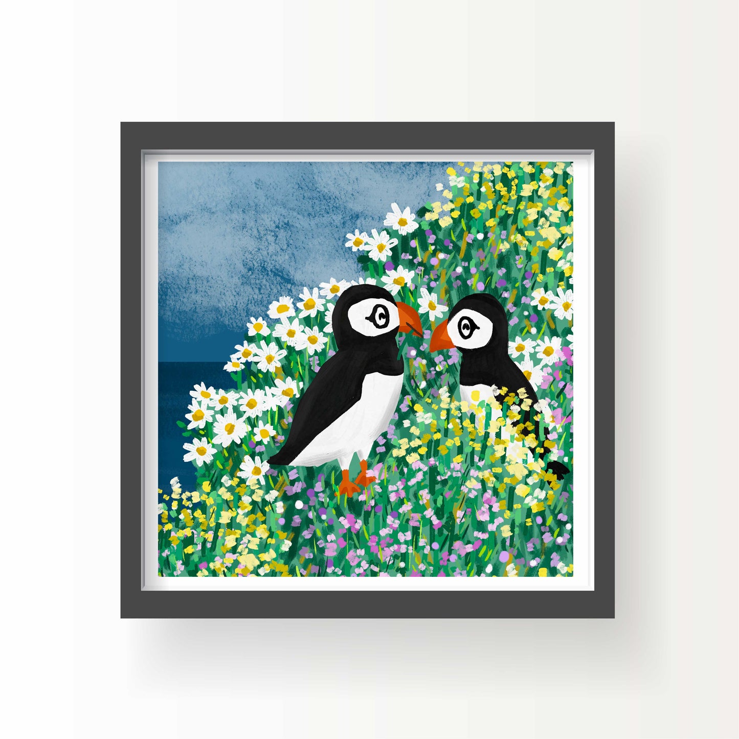 Illustration of two puffins standing in a colorful field of wildflowers with a blue sky and ocean backdrop, 8x8 art print by Miss Johnny Squirrel