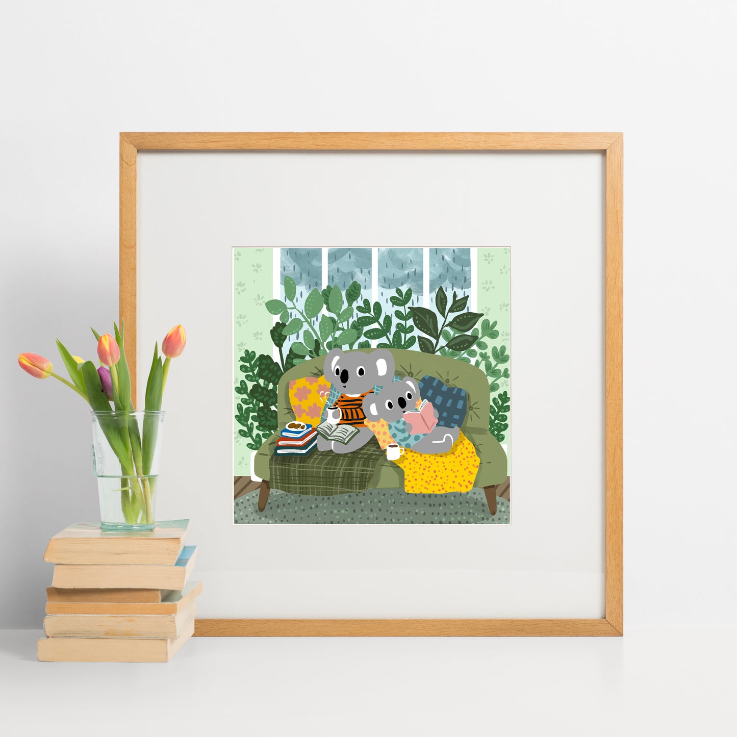 Two cozy koalas reading on a green couch surrounded by plants on a rainy day, illustrated art print by Miss Johnny Squirrel