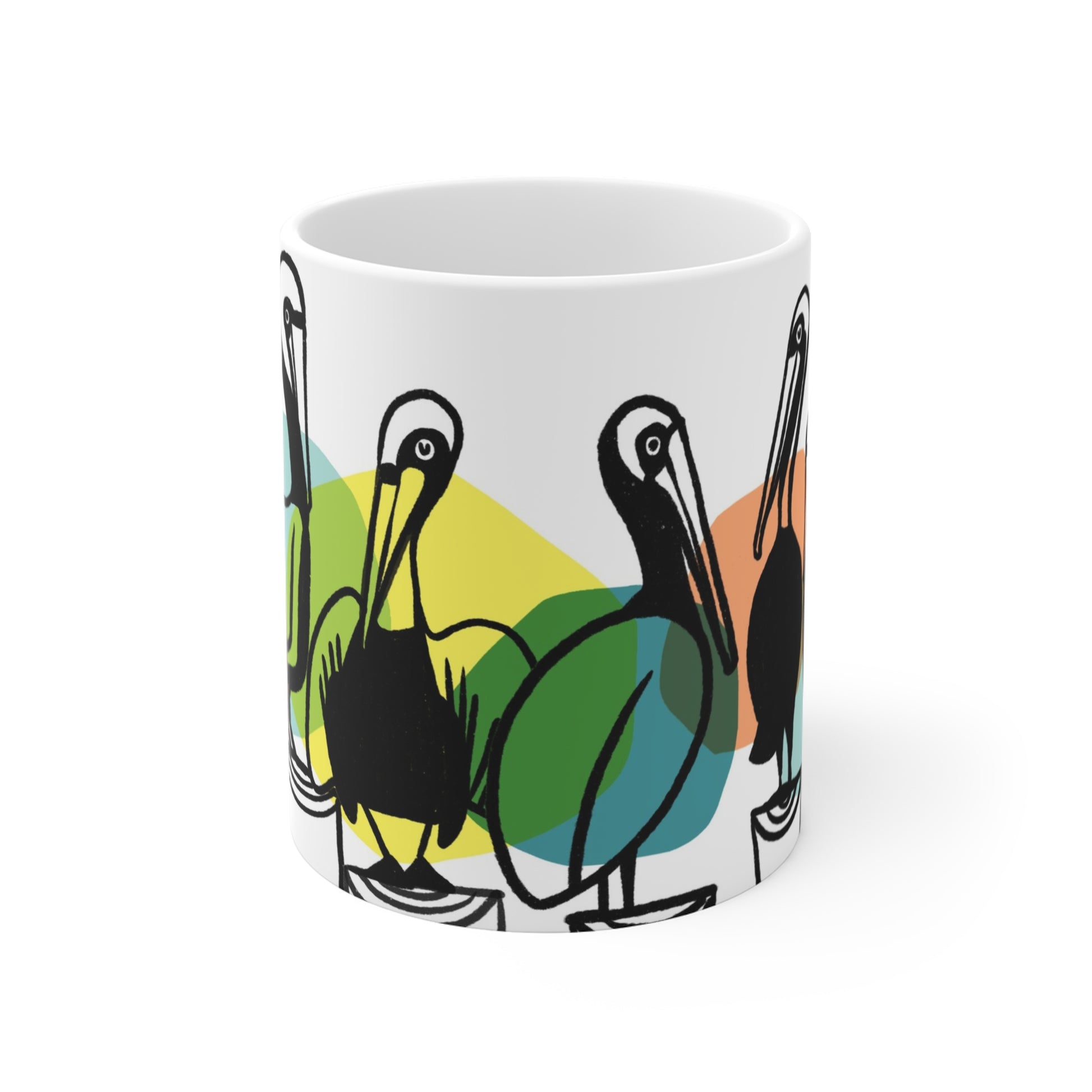 White ceramic mug featuring illustrated pelicans lined up on pilings with colorful abstract shapes behind them