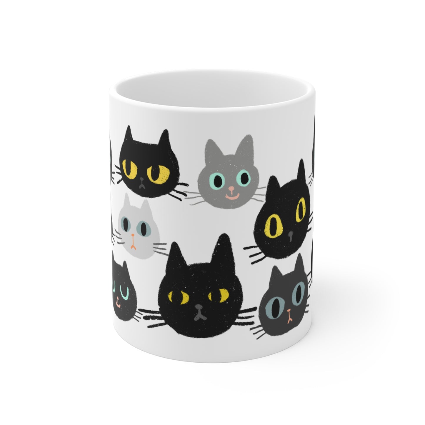 Ceramic mug featuring rows of illustrated cat faces in black, gray, and white tones with playful, wide-eyed expressions.