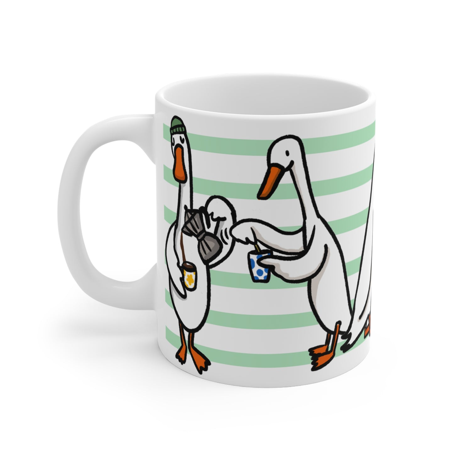 White ceramic mug featuring illustrated ducks drinking coffee, holding mugs, and sharing croissants on a green striped background.