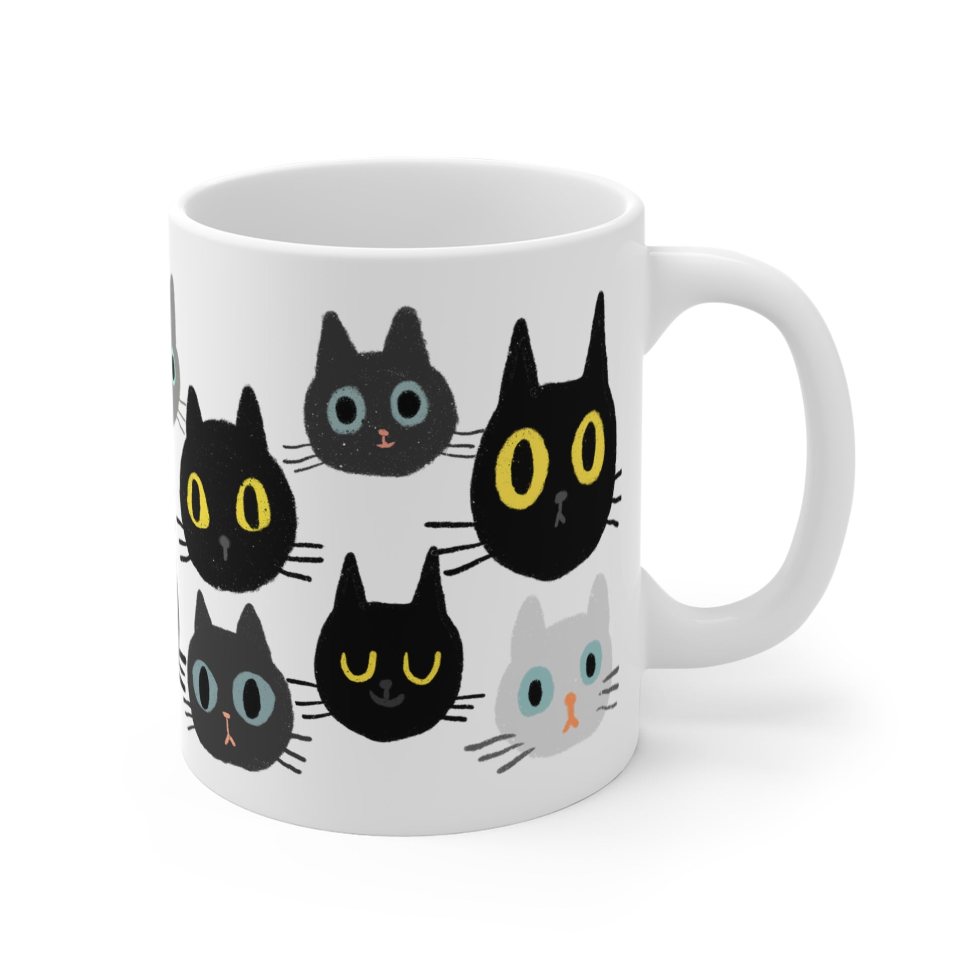 Ceramic mug featuring rows of illustrated cat faces in black, gray, and white tones with playful, wide-eyed expressions.