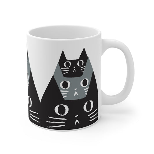 Ceramic mug featuring a pattern of black and gray cat faces with wide eyes, modern minimalist cat illustration
