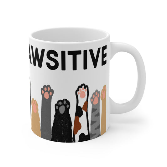 White ceramic mug with illustrated cat paws in various colors and the phrase “Always Pawsitive” around the top.