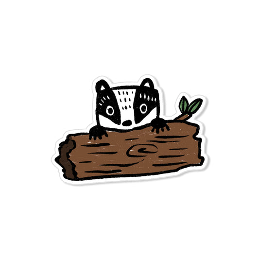 Badger sticker with black-and-white face peeking over log, hand-drawn woodland animal illustration