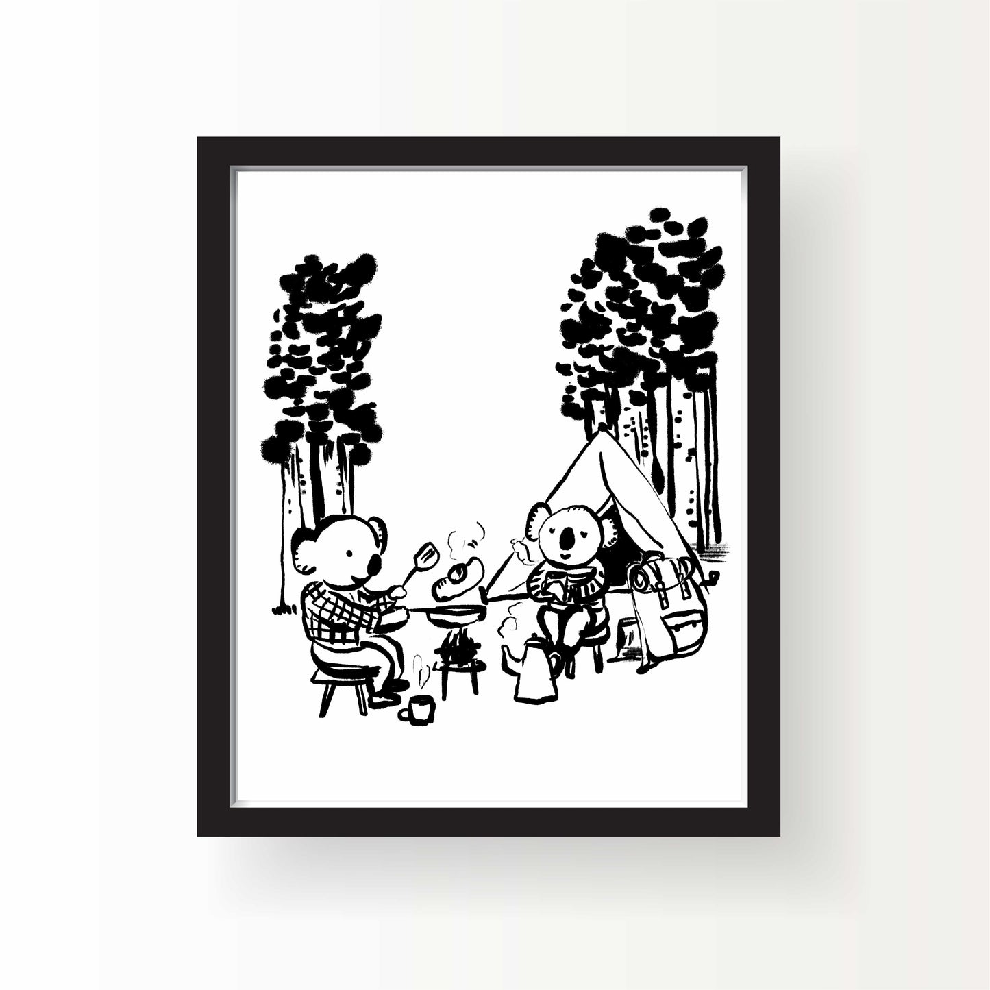 Black and white illustration of two koalas sitting at a campfire with a tent and pine trees behind them, roasting food and sipping from mugs in a forest setting.