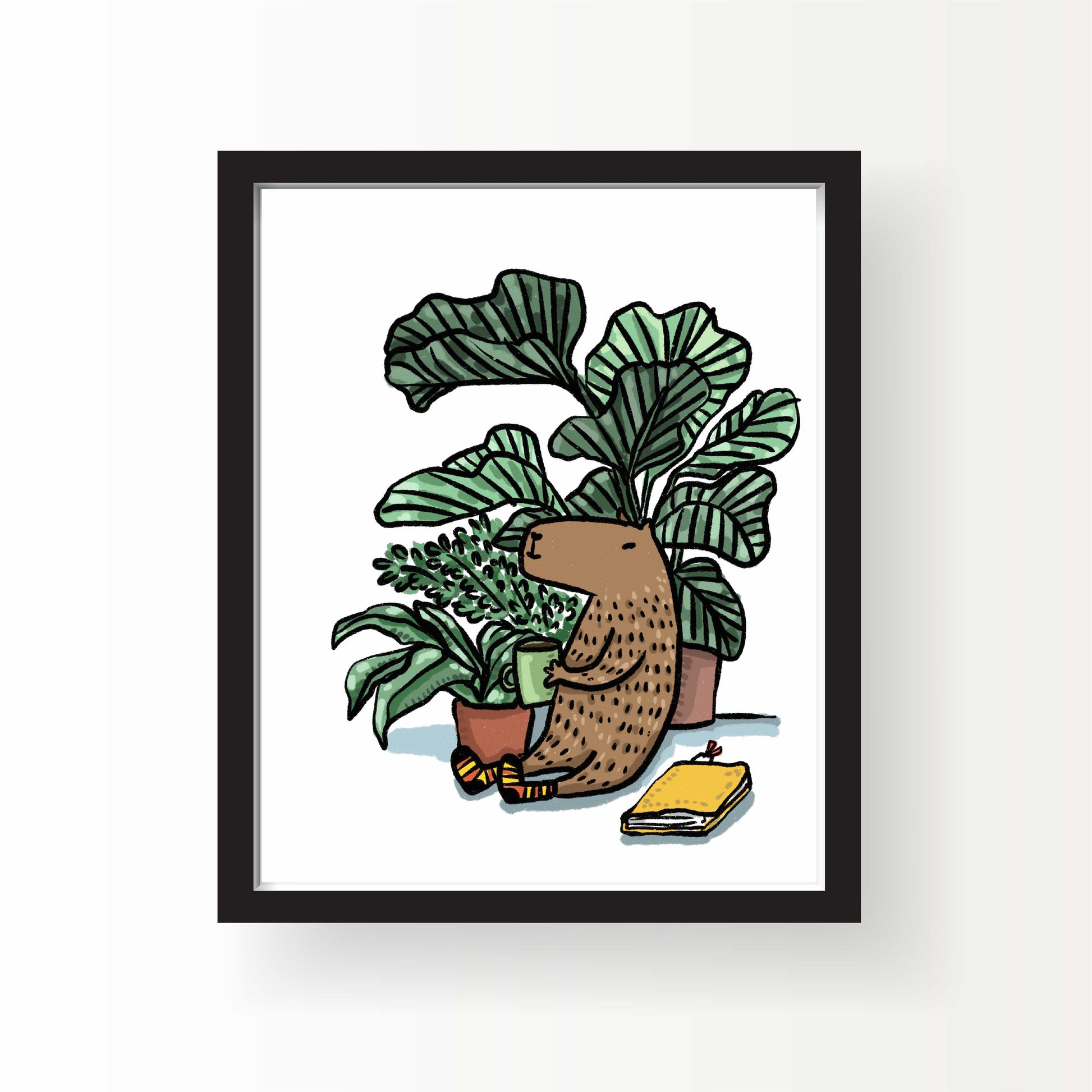 Illustration of a capybara sitting among houseplants holding a coffee mug, with cozy socks and a yellow notebook beside, 8x10 art print by Miss Johnny Squirrel