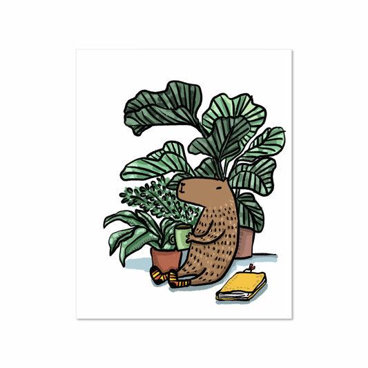Illustration of a capybara sitting among houseplants holding a coffee mug, with cozy socks and a yellow notebook beside, 8x10 art print by Miss Johnny Squirrel