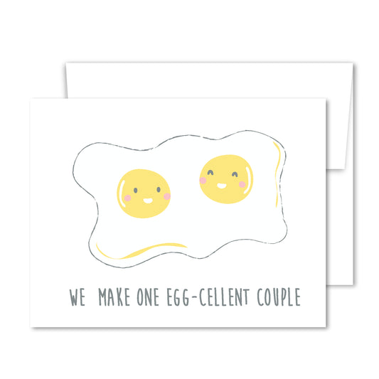 Illustration of two smiling sunny-side-up eggs with the phrase “We Make One Egg-Cellent Couple” on a love greeting card.