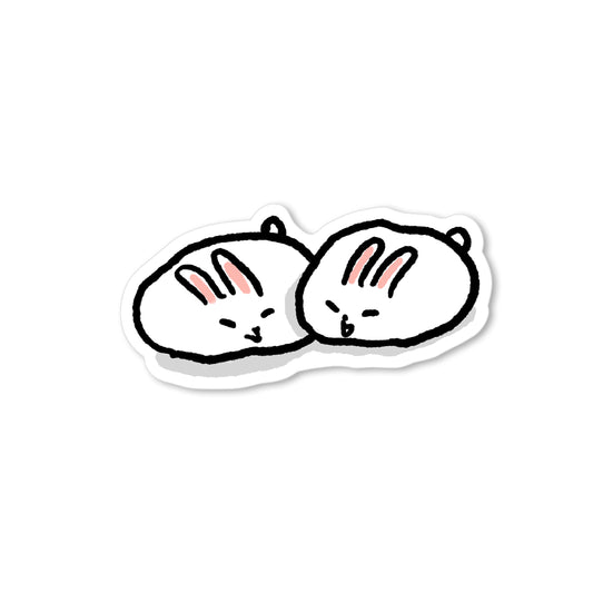 Two round white bunnies resembling soft mochi buns snuggled together, with tiny faces and pink ears in a hand-drawn illustration.
