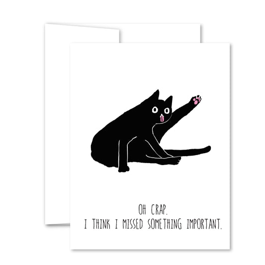 Humorous greeting card with a black cat sitting with raised paw, pink tongue, and text “Oh crap. I think I missed something important.”