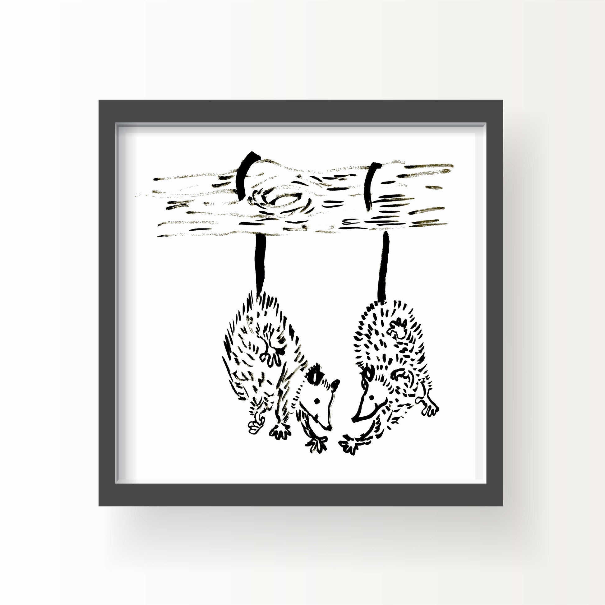 Black and white illustration of two opossums hanging upside down by their tails from a tree branch, gently reaching toward one another.