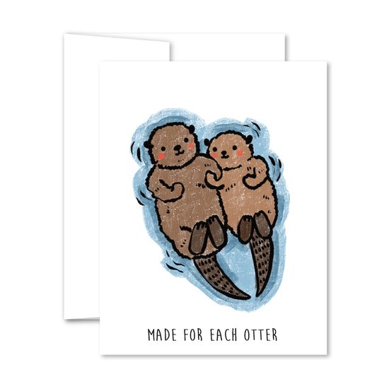 Illustrated two otters floating hand-in-hand in blue water, “Made for Each Otter” love greeting card