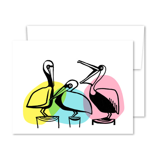 Greeting card with three pelicans illustrated in bold line art and bright watercolor-style shapes, perched on dock posts—symbolizing friendship and connection.