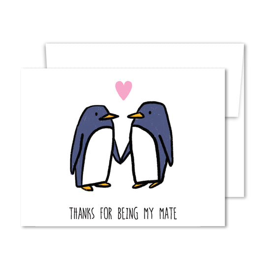 Two illustrated penguins holding flippers with a pink heart above, text “Thanks for being my mate” on friendship greeting card.