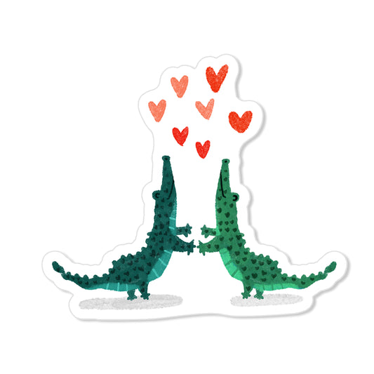 Dancing gators sticker with two green alligators holding hands and red hearts, hand-drawn illustration