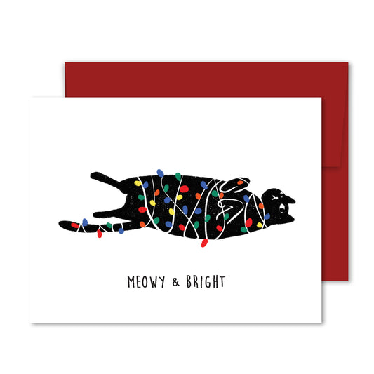 Greeting card with black cat illustration tangled in colorful Christmas lights, with text “Meowy & Bright.”